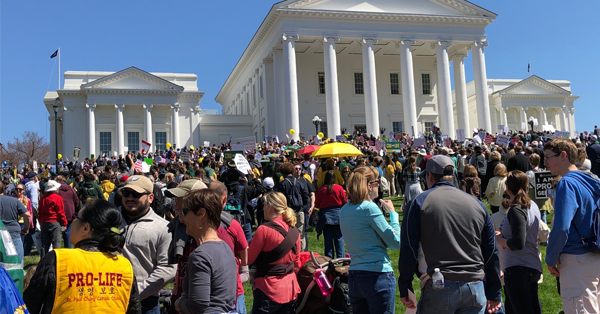 A large group of pro-life protesters in front of the Capitol.